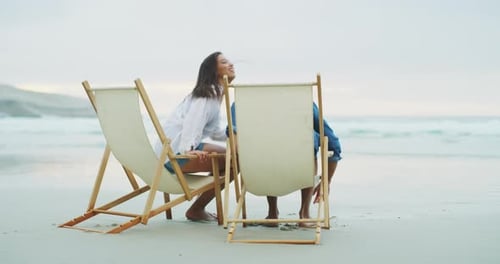 Beach, chair and couple happiness, relax and sitting on relationship date