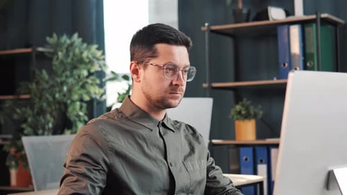 Entrepreneur Writing on the Paper Working on Laptop Making Notes in Office