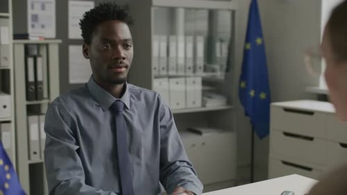 Black Man Having Visa Interview with Consular Officer at EU Embassy