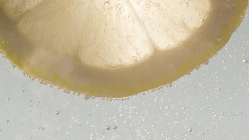 Lemon Slice Immersed in Sparkling Clear Water