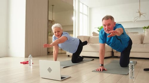 Senior Couple Doing Yoga at Home Together