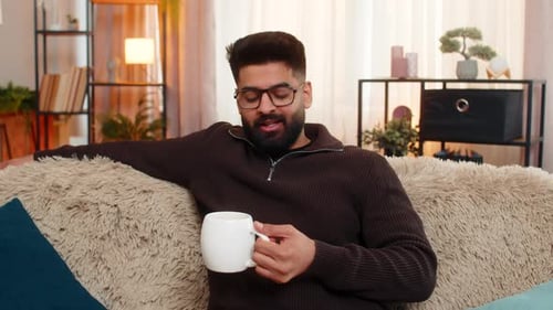 Man Relaxing and Drinking Coffee on Comfortable Couch