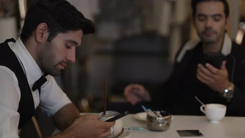 Customer play smart phone at night club.