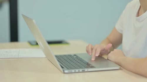 Side View of Hands Typing on Laptop