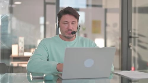 Call Center Employee with Headset Looking at Camera