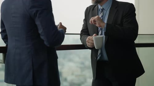 Businessmen Discussing in Modern Office Building