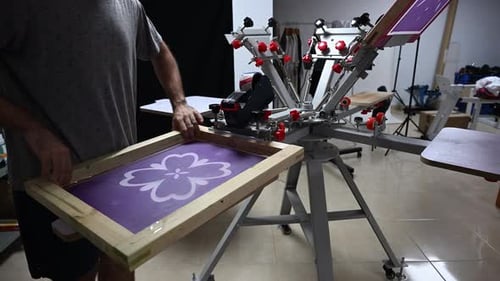Man Screen Printing in a Workshop