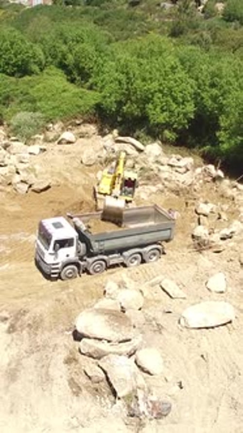 Vertical Video of Excavator Working with Truck