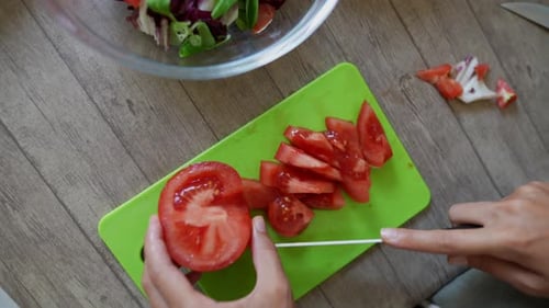 Chopping Tomatoes for Salad Preparation
