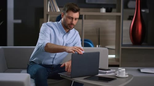 Financial Manager Using Computer Looking Screen in Home Office. Young Businessman Finish