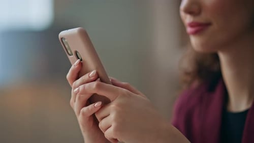 Woman Interacting with Mobile Phone Indoors