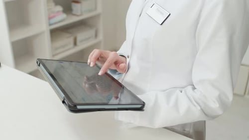 Woman Managing Stock in Pharmacy
