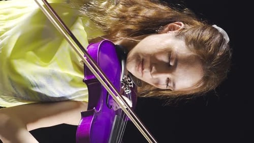 Vertical Video of The female violinist plays the violin at the music school.