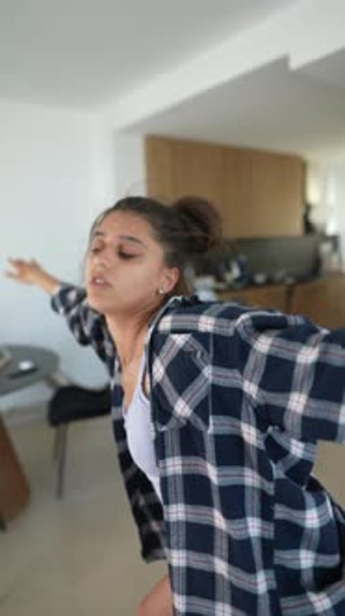Stylish Woman Dancing Barefoot in a Modern Home