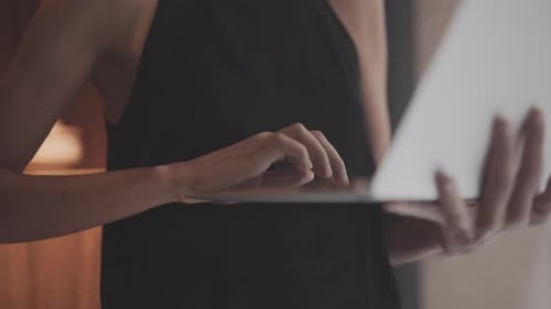 Woman Typing on Laptop in Modern Interior