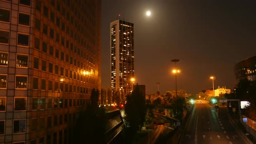 Experience the Urban Night Scenery with Moonlit Highrise Buildings and a Stunning City Skyline