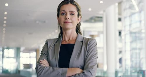 Confident Woman Stands in Elegant Corporate Office