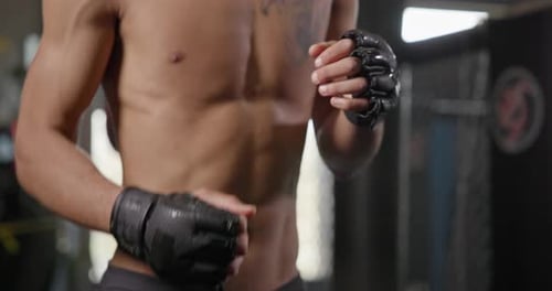 Man Shadow Boxing in Gym Wearing Gloves