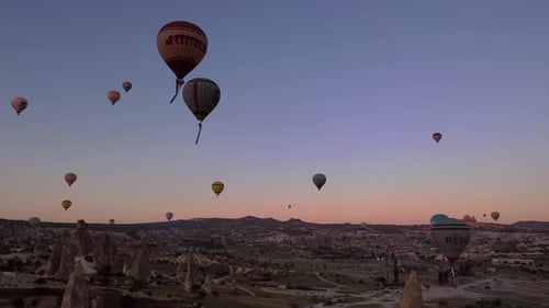 Hot Air Balloons Soaring Over Scenic Landscape at Sunrise