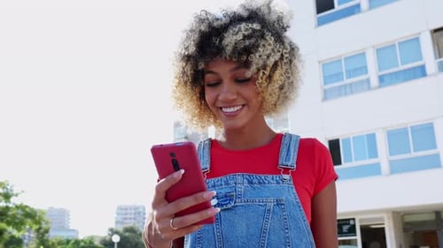 Young Latin American Woman Using Mobile Phone at City Street