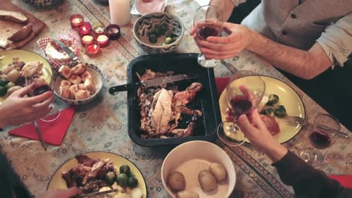 People Sharing Roast Dinner at Table Together