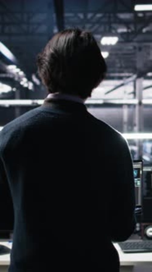 Vertical Video Admin Entering Data Center Office Reviews AI Diagnostics on Computer