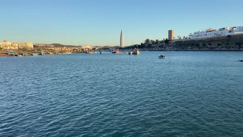 Different boats sailing Bou Regreg river in Rabat city at sunset