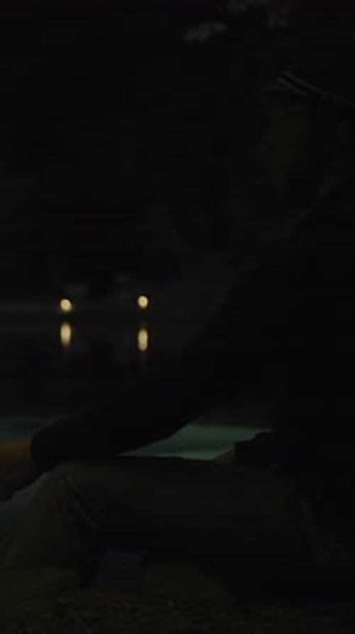 Man Holds Torch in Urban Park at Night