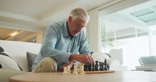 Senior Man Playing Chess at Home