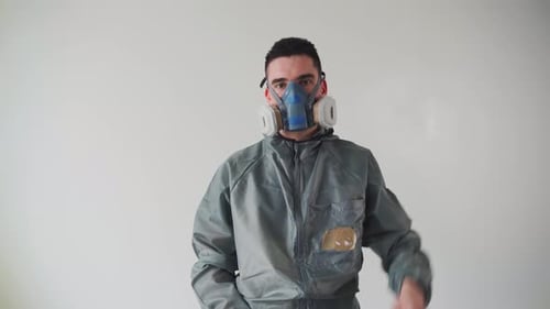 Person in Suit Removing Protective Face Mask