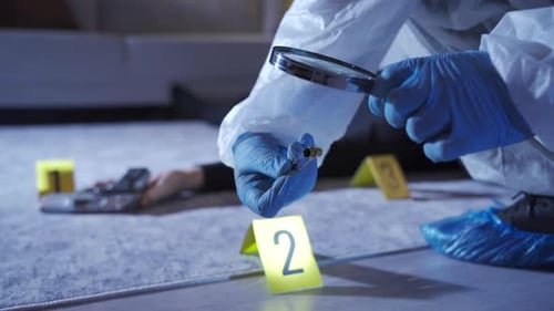 Crime Scene Investigator Examines Bullet Casing at Crime Scene