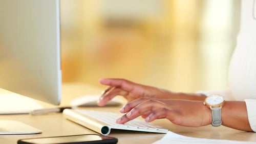Business manager writing an email on a computer