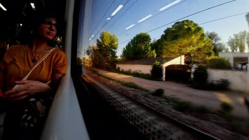 Young Adult Rides Train on Sunny Day