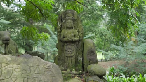 Ancient Shiva stone statue near arca nandi and ancient tablet on a forest