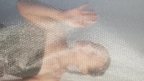 Person Under Bubble Wrap Abstract Close Up