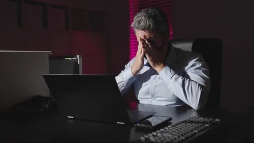 Tired Man Working Late at Office Exhausted Employee Rubbing Eyes From Fatigue Businessman Overworked