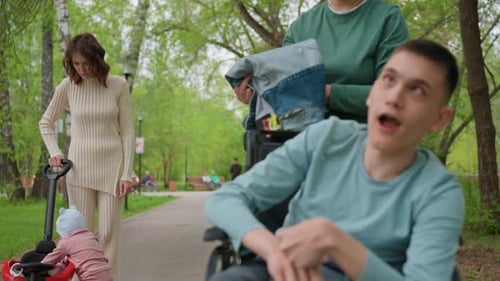 Caucasian Individual In Wheelchair Observes Peaceful Park Attentive Caucasian Man Braced In