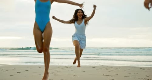 Vacation, friends and run on sand at beach for holiday, getaway or weekend trip in Bali together