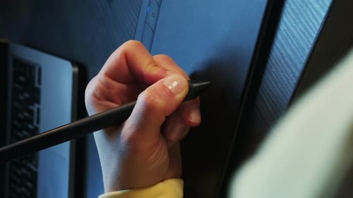 Graphic designer working with interactive pen display and stylus. Vertical video