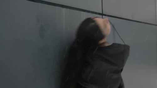 Young Woman in Black Jacket Posing in the Rain