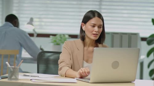 Businesswoman Web Calling on Laptop in Office