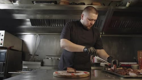 Chef Places Sliced Barbecue Meat on Platter