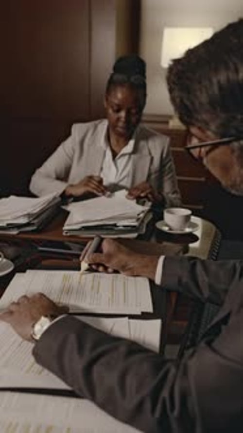 Business Meeting with Document Review in Office