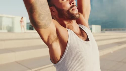 Close up, young athlete doing workout, stretching on the embankment