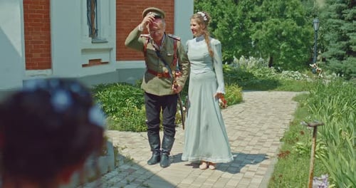 Man in a Military Uniform Walks with a Beautiful Woman in a Dress with Lace a Walk of Nobles