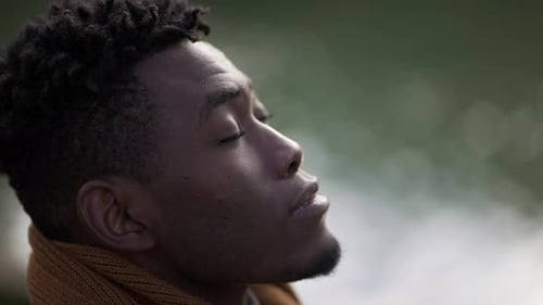 Man Looks Upward and Exhales in Cold Weather