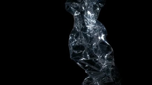Crumpled Plastic Bottle Slowly Rotating on Black