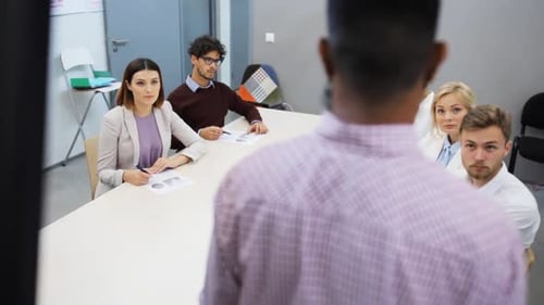 Teamwork And Corporate Concept - Business People With Papers At Presentation Or Team Building Eve...