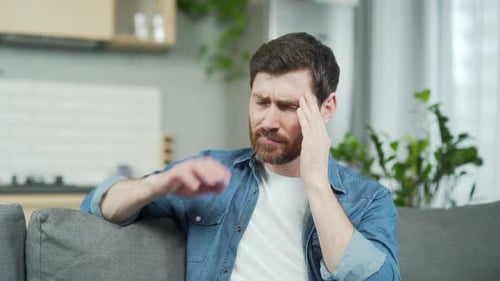 Man Experiences Headache at Home