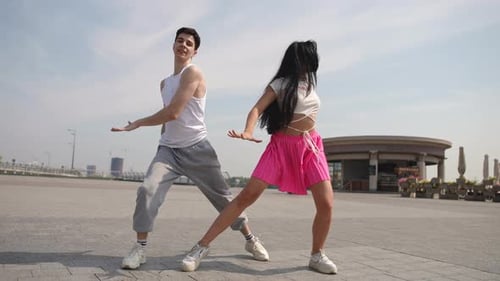 Slow Motion Low Angle Shot Street Dance on a Summer Day in a City Square Outdoors A Guy and a Girl